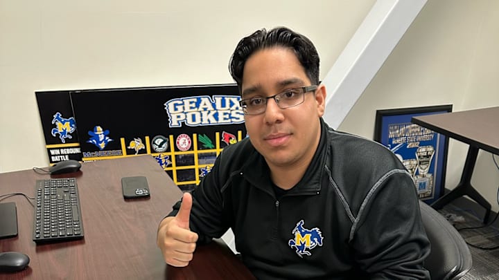McNeese basketball manager Amir Khan signs an NIL deal.