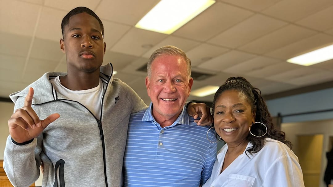 2027 football prospect Ethan Feaster and LSU coach Brian Kelly.