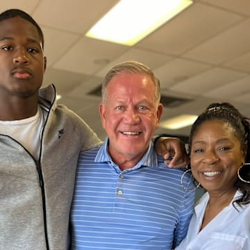 2027 football prospect Ethan Feaster and LSU coach Brian Kelly.