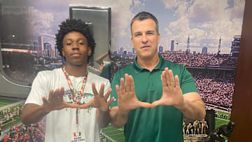 Miami Hurricanes signee Bryce Fitzgerald with head coach Mario Cristobal.