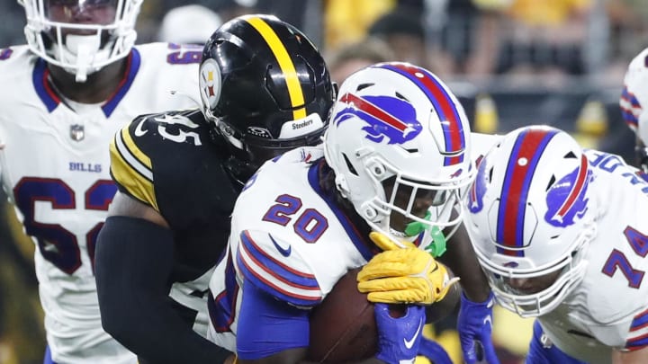 Aug 17, 2024; Pittsburgh, PA;  Buffalo Bills running back Frank Gore Jr. (20) runs the ball against Pittsburgh Steelers linebacker Jacoby Windmon (45) during the fourth quarter at Acrisure Stadium. Buffalo won 9-3.  