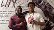Gophers defensive line coach Dennis Dottin-Carter (left) with Shakopee defensive lineman Nehemiah Ombati (right).