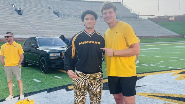 Brett Norfleet and Jude James pose at the 50 yard line at Faurot Field in June of 2023. 