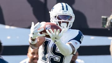Oct 5, 2025; East Rutherford, New Jersey, USA; Dallas Cowboys wide receiver Ryan Flournoy (19) makes a catch in front of New York Jets cornerback Brandon Stephens (21) during the first half at MetLife Stadium. Mandatory Credit: Vincent Carchietta-Imagn Images