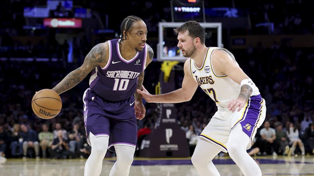 Mar 1, 2026; Los Angeles, California, USA; Sacramento Kings guard DeMar DeRozan (10) dribbles the ball against Los Angeles Lakers guard Luka Doncic (77) during the second quarter at Crypto.com Arena. Mandatory Credit: William Navarro-Imagn Images