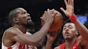 Houston Rockets forward Kevin Durant goes up to make a basket against Toronto Raptors guard Scottie Barnes.