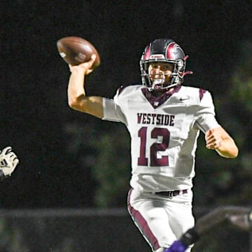 Westside High senior quarterback Cutter Woods (12) leaps to throw a pass by TL Hanna High players during the first quarter at T.L. Hanna High in Anderson, S.C. Friday, September 6, 2024.