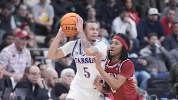Mar 20, 2025; Providence, RI, USA;  Kansas Jayhawks guard Zeke Mayo (5) controls the ball against Arkansas Razorbacks guard Boogie Fland (2) during the second half at Amica Mutual Pavilion. Mandatory Credit: Gregory Fisher-Imagn Images