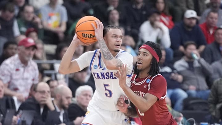 Mar 20, 2025; Providence, RI, USA;  Kansas Jayhawks guard Zeke Mayo (5) controls the ball against Arkansas Razorbacks guard Boogie Fland (2) during the second half at Amica Mutual Pavilion. Mandatory Credit: Gregory Fisher-Imagn Images
