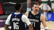 Feb 23, 2021; Dallas, Texas, USA;  Dallas Mavericks guard Luka Doncic (77) celebrates with forward James Johnson (16) after hitting the game-winning against the Boston Celtics during the fourth quarter at American Airlines Center. Mandatory Credit: Kevin Jairaj-USA TODAY Sports