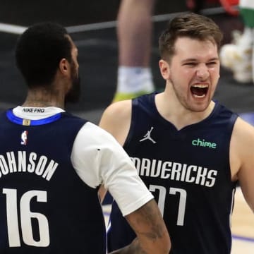 Feb 23, 2021; Dallas, Texas, USA;  Dallas Mavericks guard Luka Doncic (77) celebrates with forward James Johnson (16) after hitting the game-winning against the Boston Celtics during the fourth quarter at American Airlines Center. Mandatory Credit: Kevin Jairaj-USA TODAY Sports