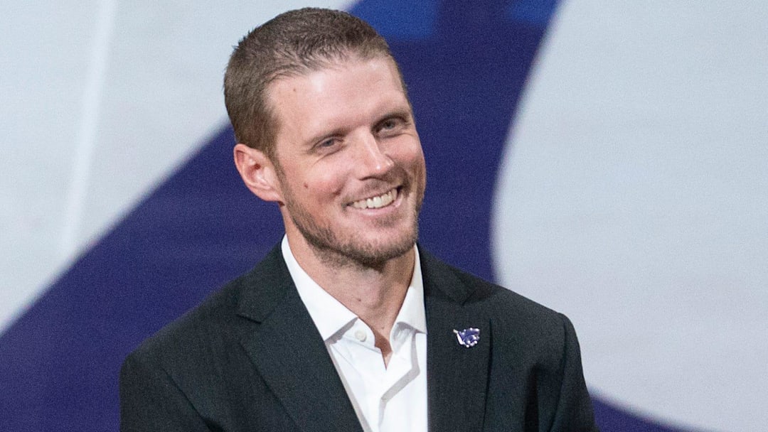 Kansas State new coach Collin Klein laughs at remarks by athletic director Gene Taylor during his introduction ceremony at Morgan Family Arena on Dec. 5, 2025.