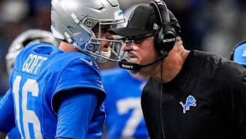 Detroit Lions quarterback Jared Goff (16) talks to head coach Dan Campbell before a play against the Green Bay Packers during the first half at Ford Field in Detroit on Thursday, Nov. 27, 2025.
