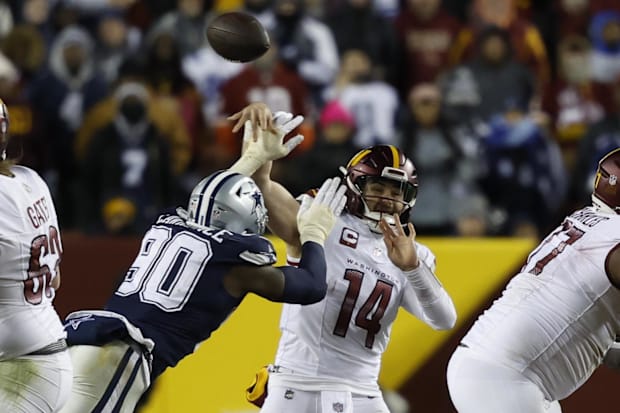 Washington Commanders quarterback Sam Howell is hit by Dallas Cowboys defensive end DeMarcus Lawrence.