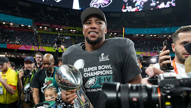 Saquon Barkley holds the Lombardi Trophy after the Eagles' win in Super Bowl LIX.