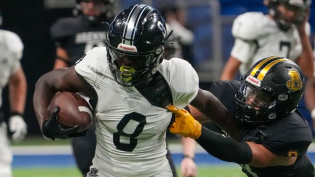 Royal Capell muscles for extra yardage during a Texas high school football showdown with San Antonio Brennan.