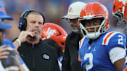 Florida head coach Billy Napier talks with Florida quarterback DJ Lagway (2) during the first half of an NCAA football game at Steve Spurrier Field at Ben Hill Griffin Stadium in Gainesville, FL on Saturday, October 18, 2025. [Alan Youngblood/Gainesville Sun]
