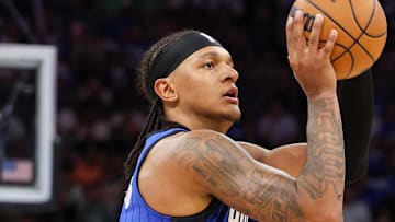 Apr 27, 2025; Orlando, Florida, USA; Orlando Magic forward Paolo Banchero (5) shoots a three point shot against the Boston Celtics in the first quarter during game four of first round for the 2025 NBA Playoffs at Kia Center. Mandatory Credit: Nathan Ray Seebeck-Imagn Images