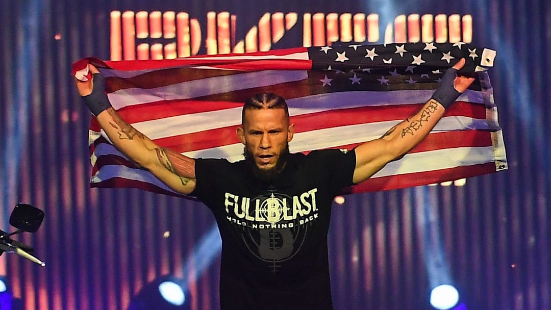 Fighter Julian Lane walks to the ring for his fight while holding up an American flag during the Bare Knuckles Championship on Saturday, Aug. 2, 2025, at the Buffalo Chip in Sturgis, South Dakota.