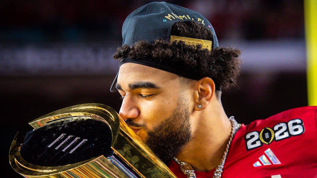 Indiana's Elijah Sarratt (13) kisses the trophy after the College Football Playoff National Championship college football game at Hard Rock Stadium in Miami Gardens on Monday, Jan. 19, 2026.