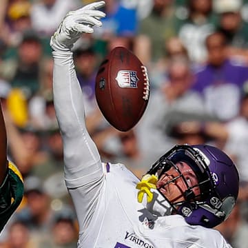 Minnesota Vikings cornerback Byron Murphy Jr. (7) breaks up a pass intended for Green Bay Packers receiver Romeo Doubs.