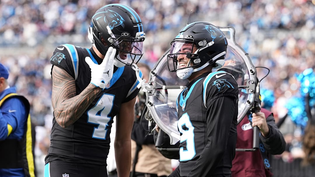 Dec 21, 2025; Charlotte, North Carolina, USA; Carolina Panthers wide receiver Tetairoa McMillan (4) and quarterback Bryce Young (9) celebrate after a play during the second half against the Tampa Bay Buccaneers at Bank of America Stadium. 