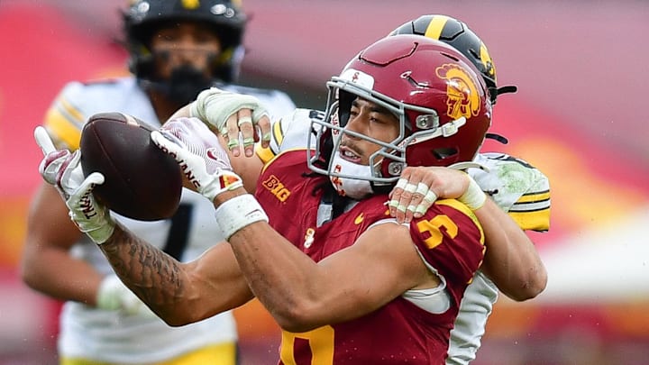 Nov 15, 2025; Los Angeles, California, USA; Southern California Trojans wide receiver Makai Lemon (6) catches a pass against the defense of Iowa Hawkeyes defensive back Zach Lutmer (6) during the second half at the Los Angeles Memorial Coliseum. Mandatory Credit: Gary A. Vasquez-Imagn Images