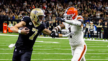Nov 17, 2024; New Orleans, Louisiana, USA;  New Orleans Saints tight end Taysom Hill (7) runs against  Cleveland Browns safety Juan Thornhill (1) during the first half at Caesars Superdome. Mandatory Credit: Stephen Lew-Imagn Images