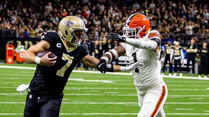 Nov 17, 2024; New Orleans, Louisiana, USA;  New Orleans Saints tight end Taysom Hill (7) runs against  Cleveland Browns safety Juan Thornhill (1) during the first half at Caesars Superdome. Mandatory Credit: Stephen Lew-Imagn Images