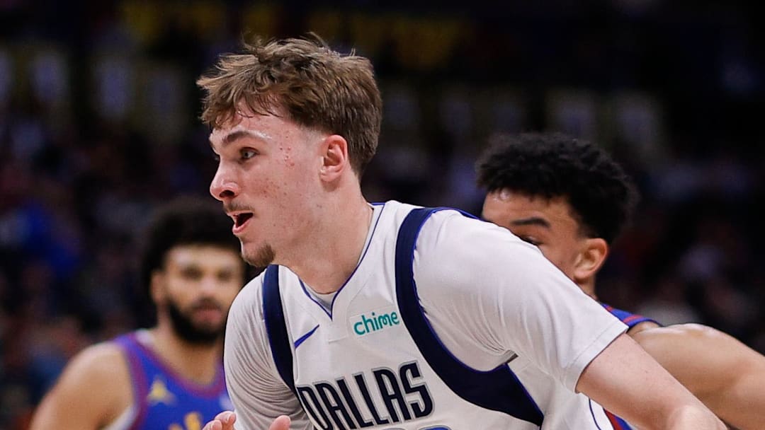Dallas Mavericks forward Cooper Flagg controls the ball ahead of Denver Nuggets forward Spencer Jones.