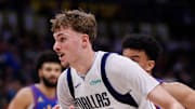 Dallas Mavericks forward Cooper Flagg controls the ball ahead of Denver Nuggets forward Spencer Jones.
