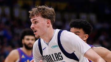 Dallas Mavericks forward Cooper Flagg controls the ball ahead of Denver Nuggets forward Spencer Jones.