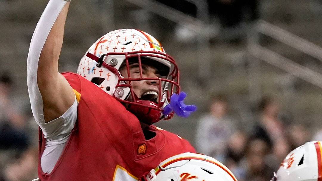 Kuemper Catholic’s Jack Badding (7) lifts Jarin Hoffman (5) into the air as the Knights celebrate their Class 2A state championship Nov. 21, 2025 after defeating the Van Meter Bulldogs at the UNI-Dome in Cedar Falls, Iowa.
