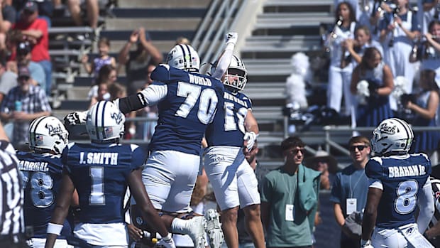 Nevada’s Marcus Bellon (18) and Isaiah World celebrate a touchdown while taking on Eastern Washington