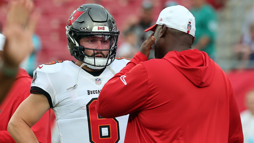 Aug 23, 2024; Tampa, Florida, USA; Tampa Bay Buccaneers head coach Todd Bowles talks with quarterback Baker Mayfield (6) at Raymond James Stadium. 