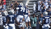 Nevada’s Marcus Bellon (18) and Isaiah World celebrate a touchdown while taking on Eastern Washington during their football game at Mackay Stadium in Reno on Sept. 21, 2024.