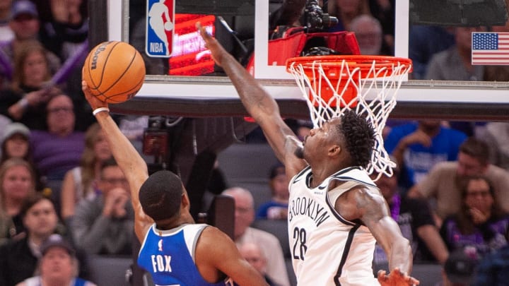 Dec 11, 2023; Sacramento, California, USA; Sacramento Kings guard De'Aaron Fox (5) puts up a shot over Brooklyn Nets forward Dorian Finney-Smith (28) during the fourth quarter at Golden 1 Center. Mandatory Credit: Ed Szczepanski-USA TODAY Sports