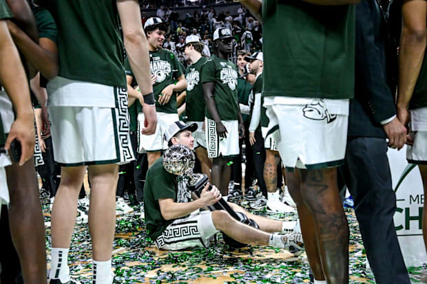 Michigan State's Frankie Fidler holds the Big Ten championship trophy after the game against Michigan.