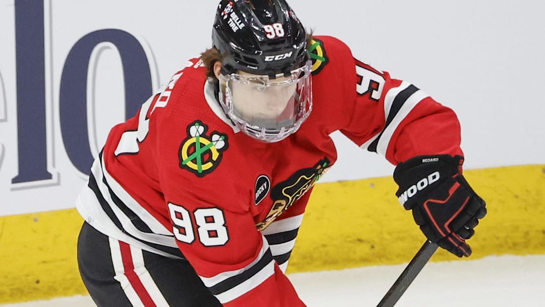 Feb 25, 2024; Chicago, Illinois, USA; Chicago Blackhawks center Connor Bedard (98) looks to pass the puck against Detroit Red Wings right wing Patrick Kane (88) during the second period at United Center. Mandatory Credit: Kamil Krzaczynski-Imagn Images