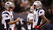 Nov. 30, 2009; New Orleans, LA, USA; New England Patriots quarterback Tom Brady (12) bump fists with wide receiver Randy Moss (81) during pregame warmups against the New Orleans Saints at the Louisiana Superdome. 
