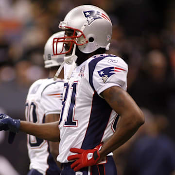 Nov. 30, 2009; New Orleans, LA, USA; New England Patriots quarterback Tom Brady (12) bump fists with wide receiver Randy Moss (81) during pregame warmups against the New Orleans Saints at the Louisiana Superdome. 