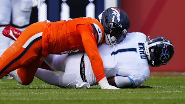 Denver Broncos linebacker Nik Bonitto (15) sacks Tennessee Titans quarterback Cam Ward (1) in the first half.