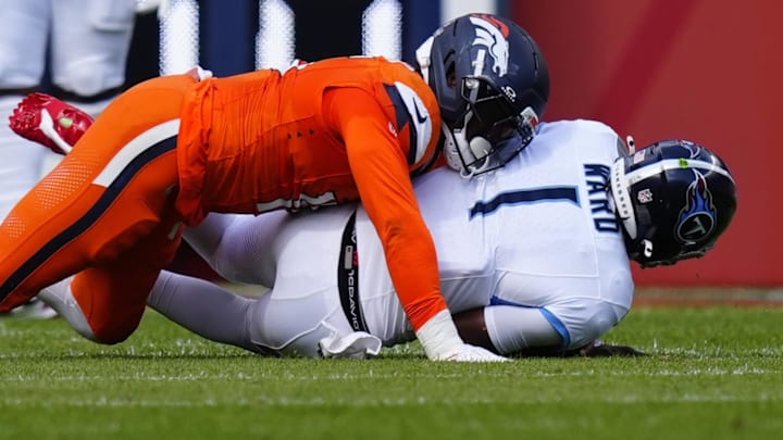 Sep 7, 2025; Denver, Colorado, USA; Denver Broncos linebacker Nik Bonitto (15) sacks Tennessee Titans quarterback Cam Ward (1) in the first half at Empower Field at Mile High. 