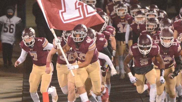 Anthony Oates leads Killingly onto Rentschler Field.