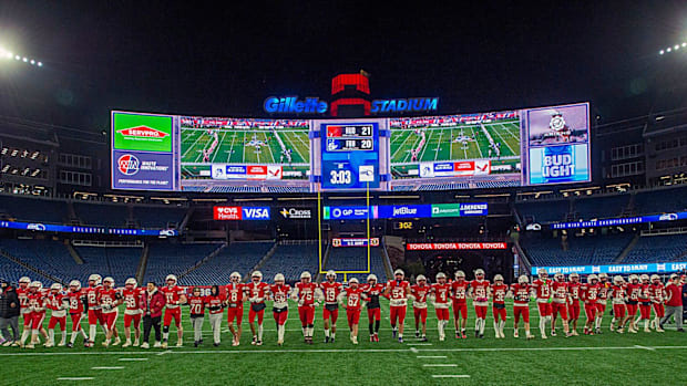 The Hudson High School football team walks to midfield for the National Anthem in the state Div. 6 championship at Gillette S