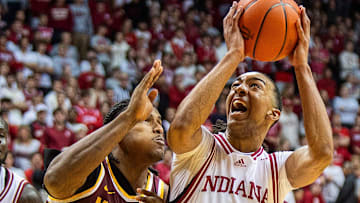 Indiana's Bryson Tucker looks to shoot over Minnesota's Frank Mitchell in December. Tucker has joined the UW now. 