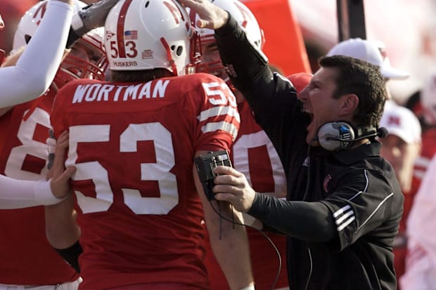 Nebraska Cornhuskers linebackers coach Mike Ekeler (right) celebrates with Tyler Wortman (53).
