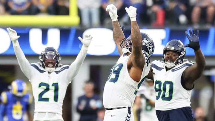 Jan 5, 2025; Inglewood, California, USA; Seattle Seahawks Defensive End Leonard Williams (99), Free Safety Devon Witherspoon (21) and Nose Tackle Jarred Reed (90) celebrate a 4th down stop at SoFi Stadium, as the Seattle Seahawks face off versus the Los Angeles Rams Week 18 matchup.