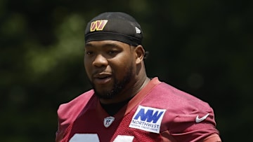 Washington Commanders defensive tackle Daron Payne stands on the field on day one of minicamp.