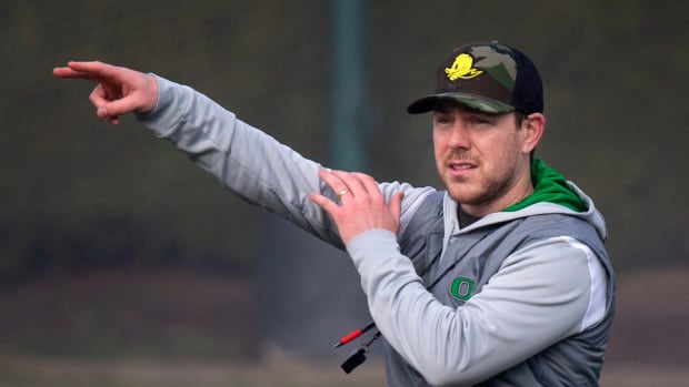 Oregon offensive coordinator and quarterbacks coach Will Stein leads a drill on the first practice 